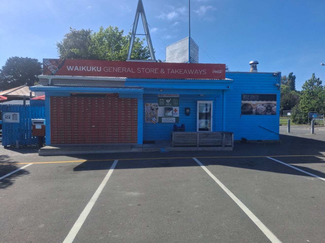 Blue Waikuku General Store & Takeaways storefront with its red name sign