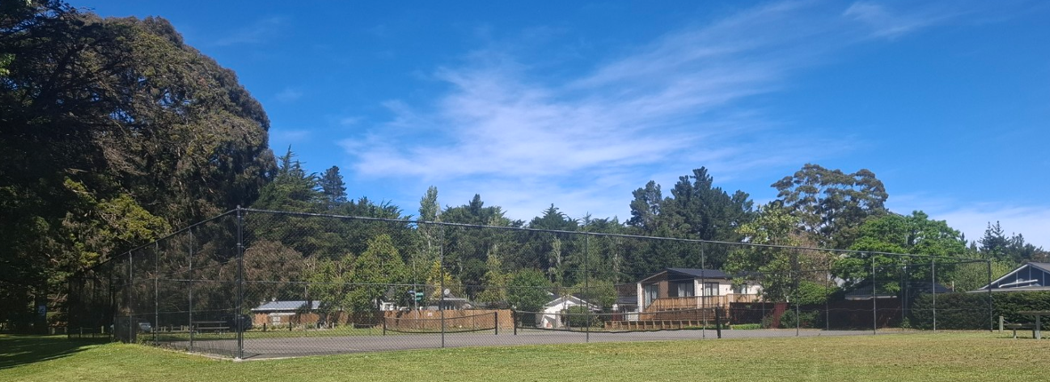 Waikuku Beach tennis courts behind the wire fence